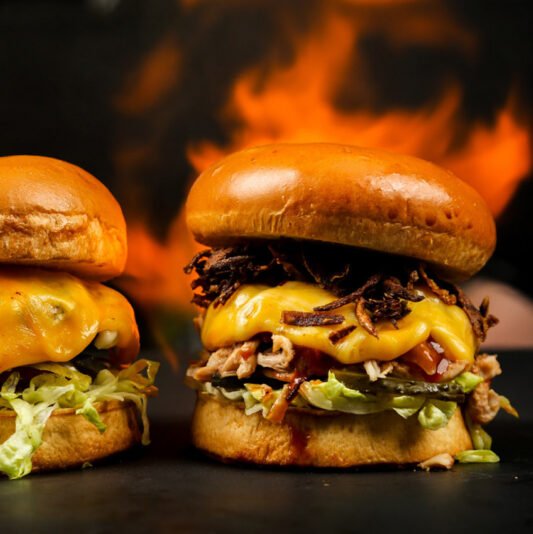 two tasty burgers behind the fire