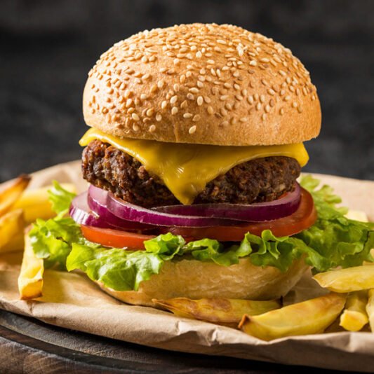 Tasty Cheeseburger behind fries